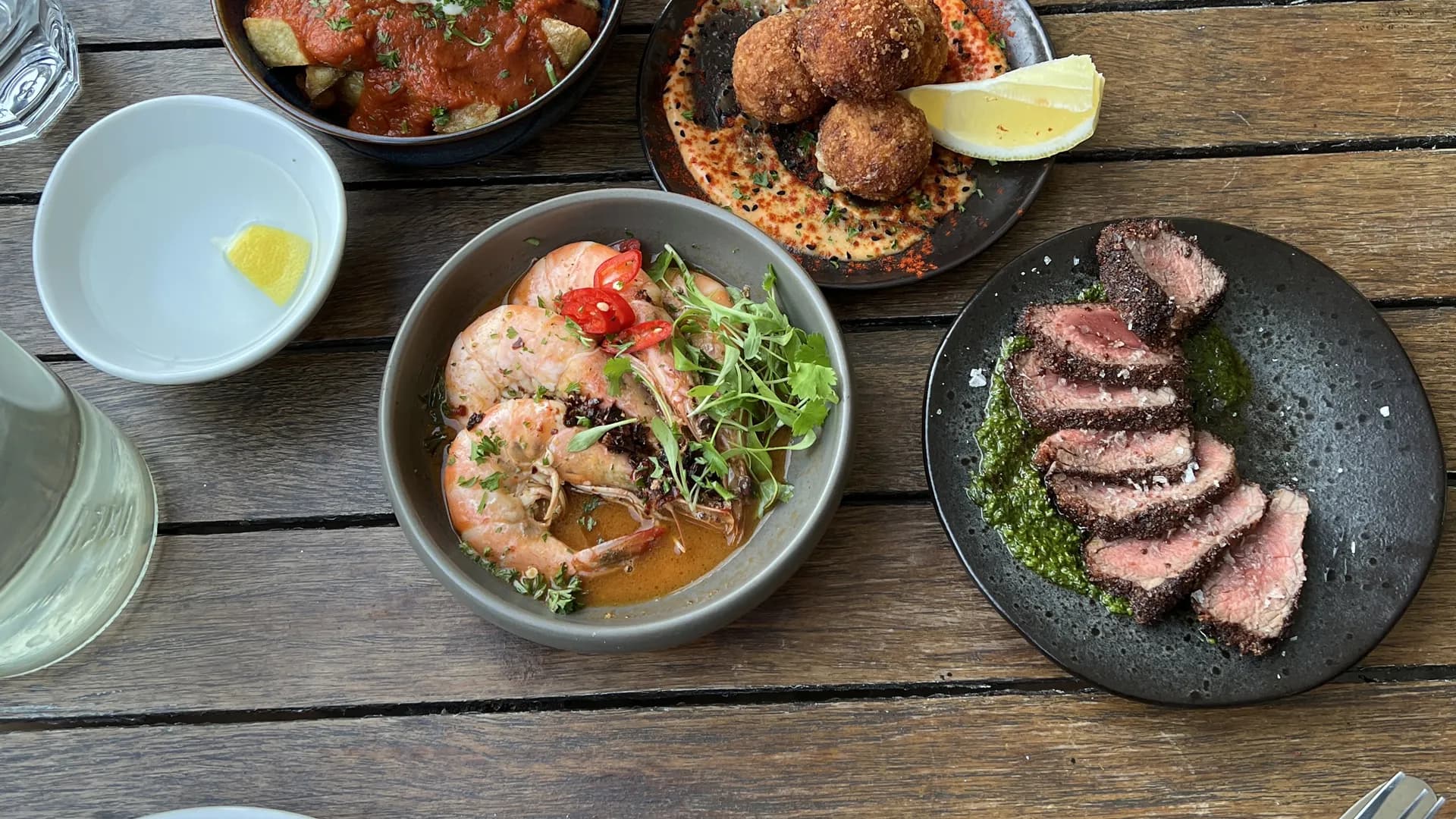 Our table of prawns, arancini and steak at Under the Stars on Bristol Harbourside